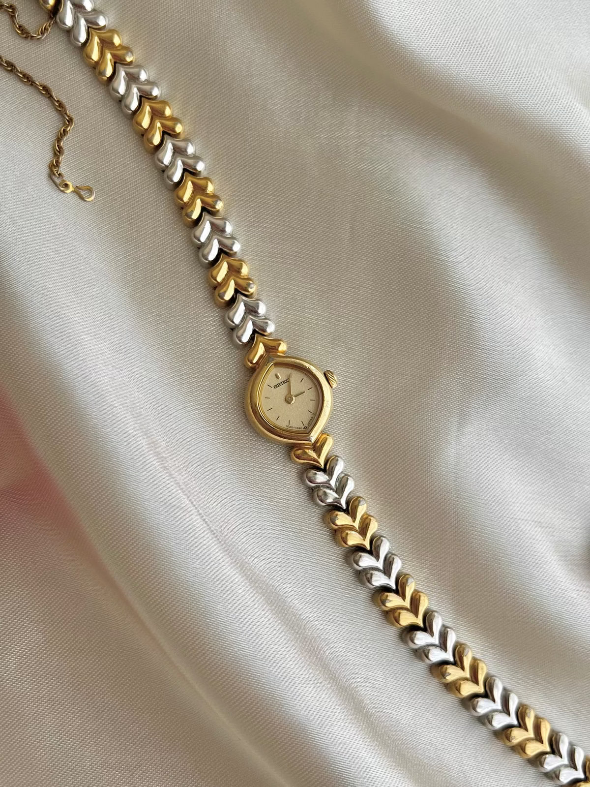 Seiko Champagne Dial Tear Drop Watch with Two-Tone Leaf-Link Bracelet, wrist shot of a vintage women's watch at Gilded Hour.