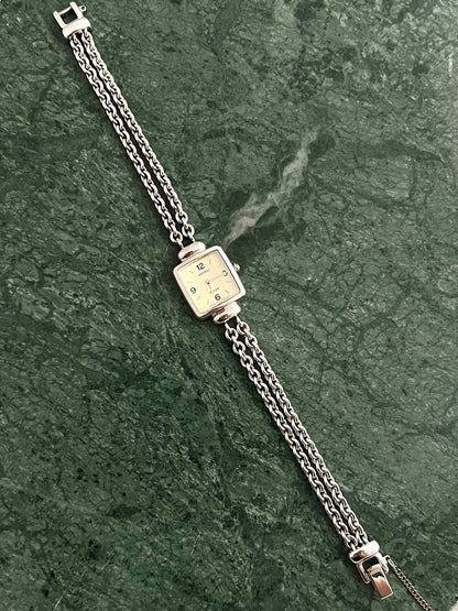 Angled view of the Seiko Tissé soft-square case and double-chain bracelet.
