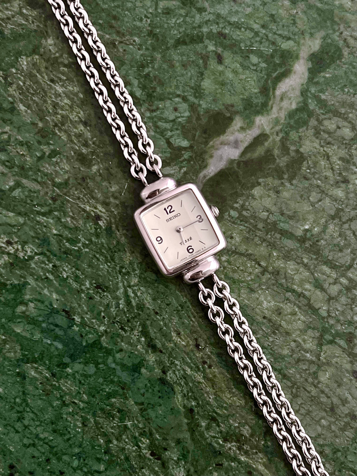 Seiko Tissé double-strand silver bracelet watch shown on a wrist.