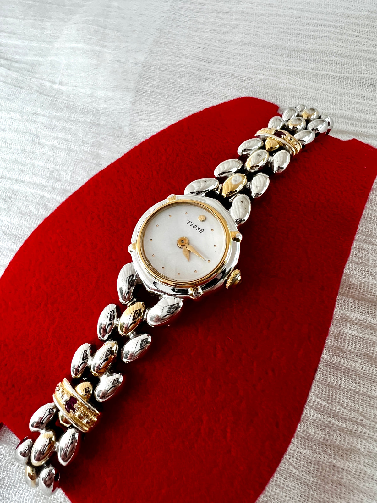 Seiko Tisse Mother of Pearl Women’s Watch with Ruby Bracelet Accents — dial and open marquise bracelet links.