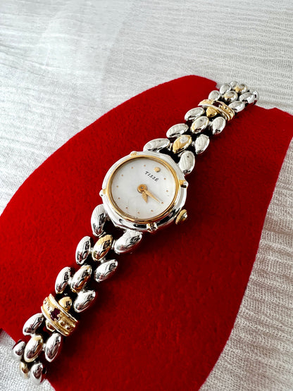 Seiko Tisse Mother of Pearl Women’s Watch with Ruby Bracelet Accents — dial and open marquise bracelet links.