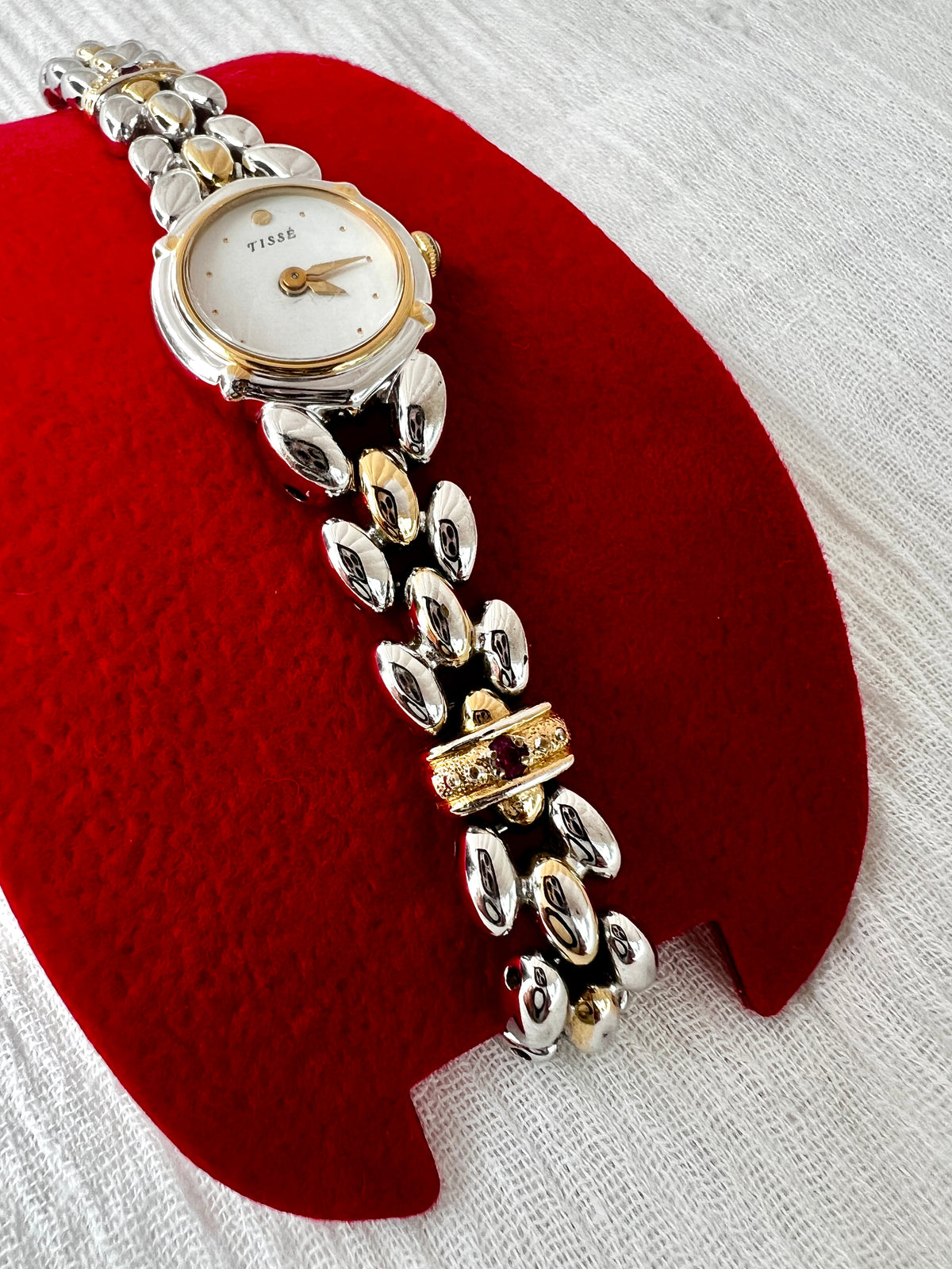Seiko Tisse Mother of Pearl Women’s Watch with Ruby Bracelet Accents — close view of dial and ruby accented connector.