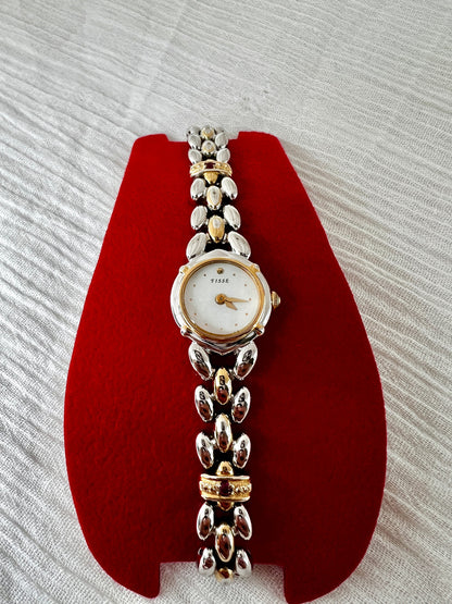 Seiko Tisse Mother of Pearl Women’s Watch with Ruby Bracelet Accents — watch and bracelet on a red cushion.