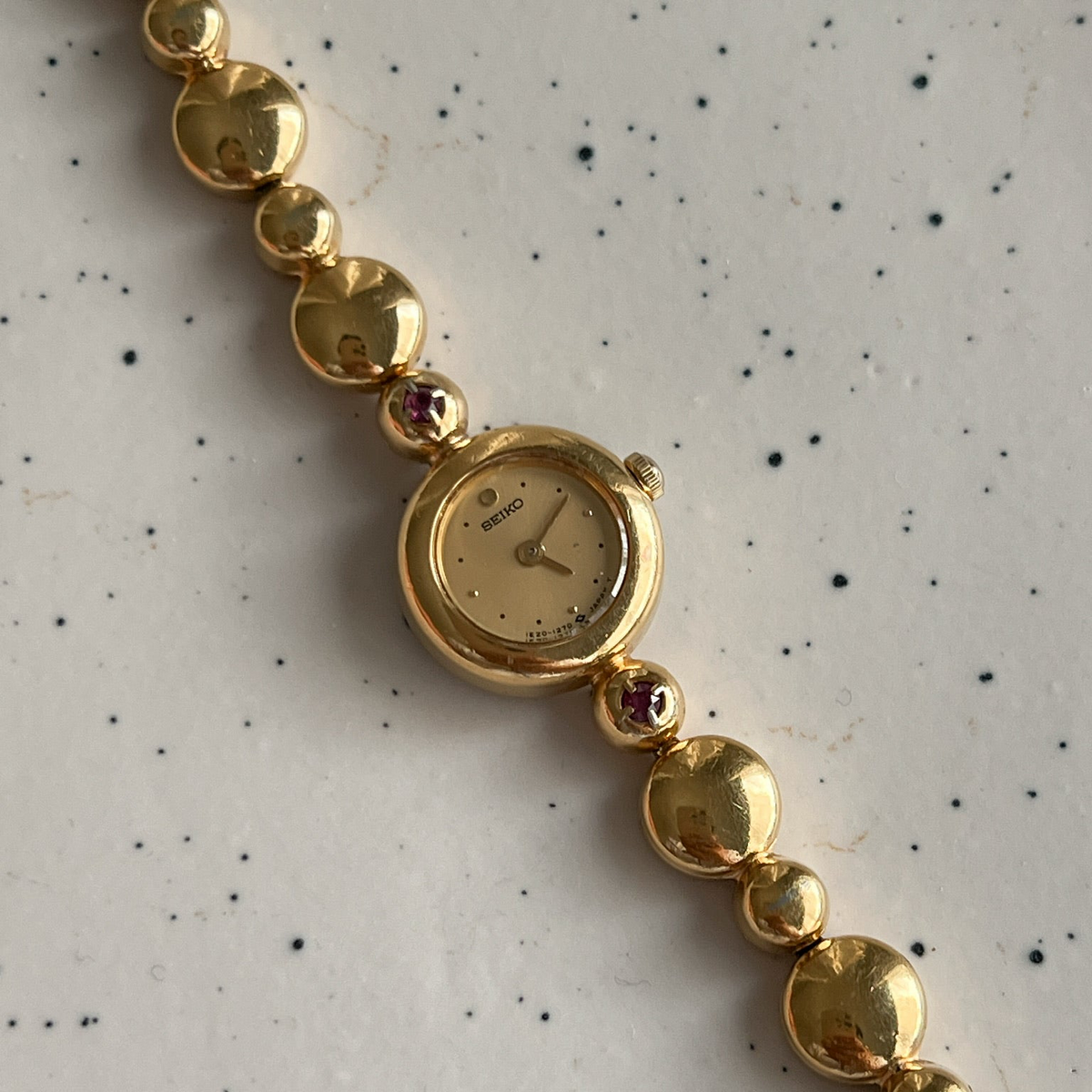 Seiko Tissé Ruby Accent Bubble Bracelet Women’s Watch featuring champagne dial; vintage watch product image 2.