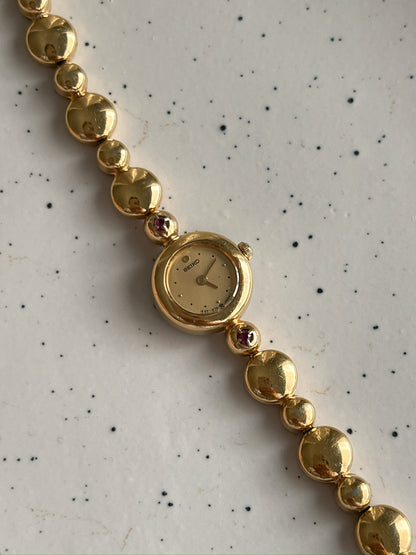 Seiko Tissé Ruby Accent Bubble Bracelet Women’s Watch featuring champagne dial; vintage watch product image 3.