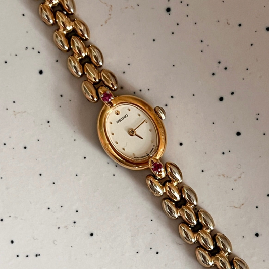 Seiko Tissé Ruby Accent Rice Bracelet Women’s Watch featuring champagne dial and rice bracelet; vintage watch product image 1.
