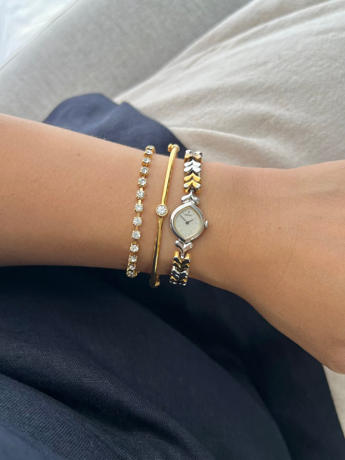 Seiko Silver Teardrop Women’s Watch with Two Tone Leaf Bracelet — watch worn on the wrist.