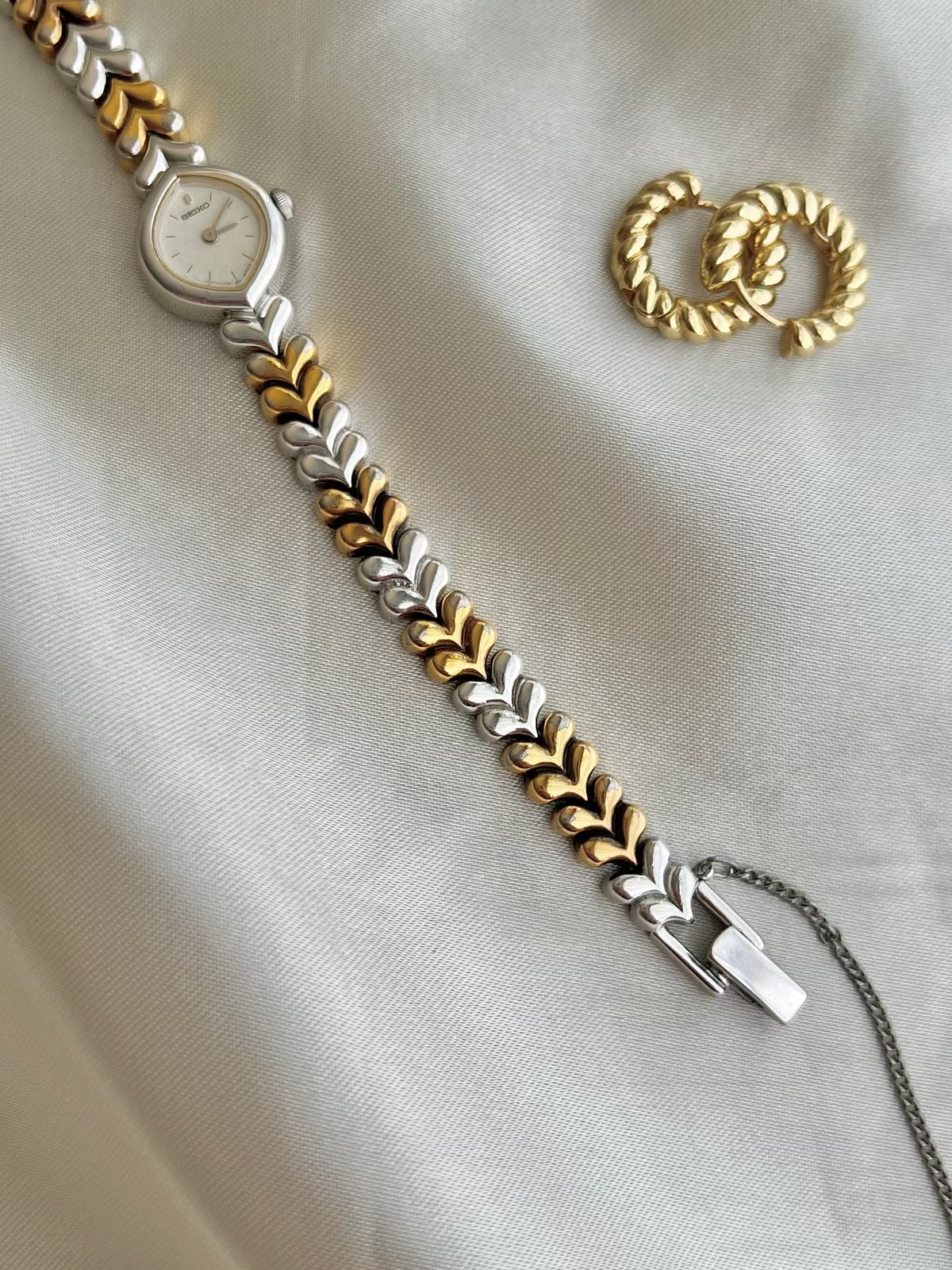Seiko Silver Teardrop Women’s Watch with Two Tone Leaf Bracelet — watch beside gold tone jewellery.