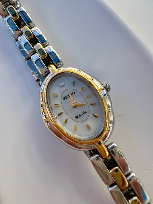 Featured product image: Seiko Tisse solar women's watch with gold indices, mother-of-pearl dial, and diamond marker.