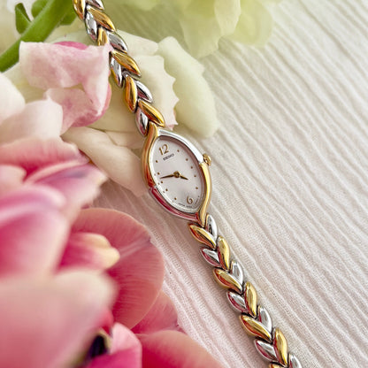 Seiko Tisse women's teardrop watch with white dial and two-tone leaf-link bracelet.