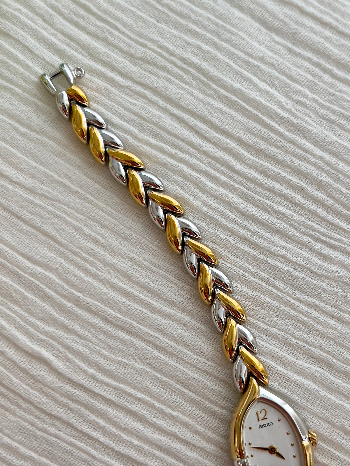 Detail of the two-tone leaf-link bracelet on the Seiko watch.