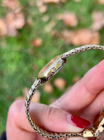 Seiko Gold Toned Oval Watch with a Wreath Textured Case — close view of the watch band and clasp.