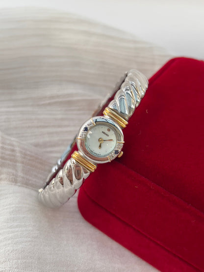 Seiko Bangle Woman's Watch – Two-Tone with Sapphire and Diamond Accents — close view of the watch band and clasp.