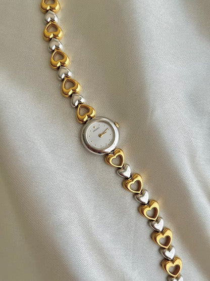Angled view of the Seiko two-tone hearts bracelet watch.