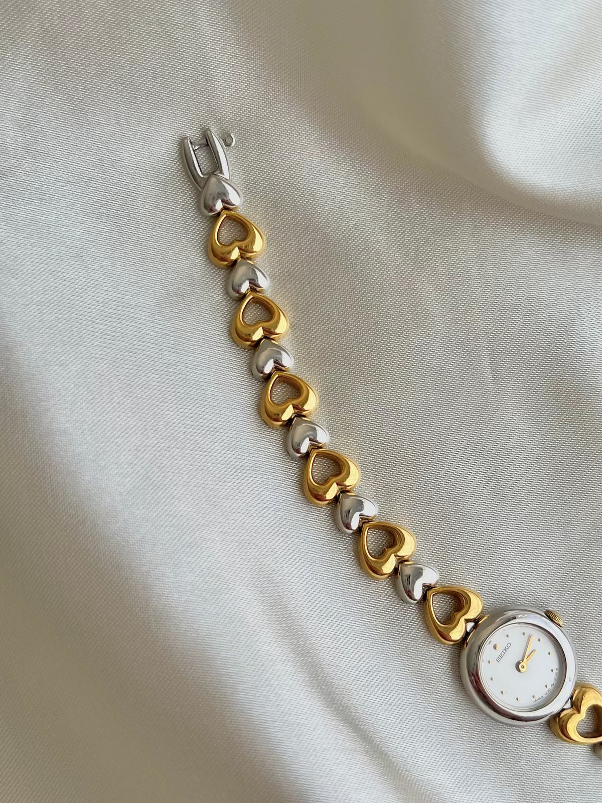 Detail of the Seiko two-tone heart-link bracelet.