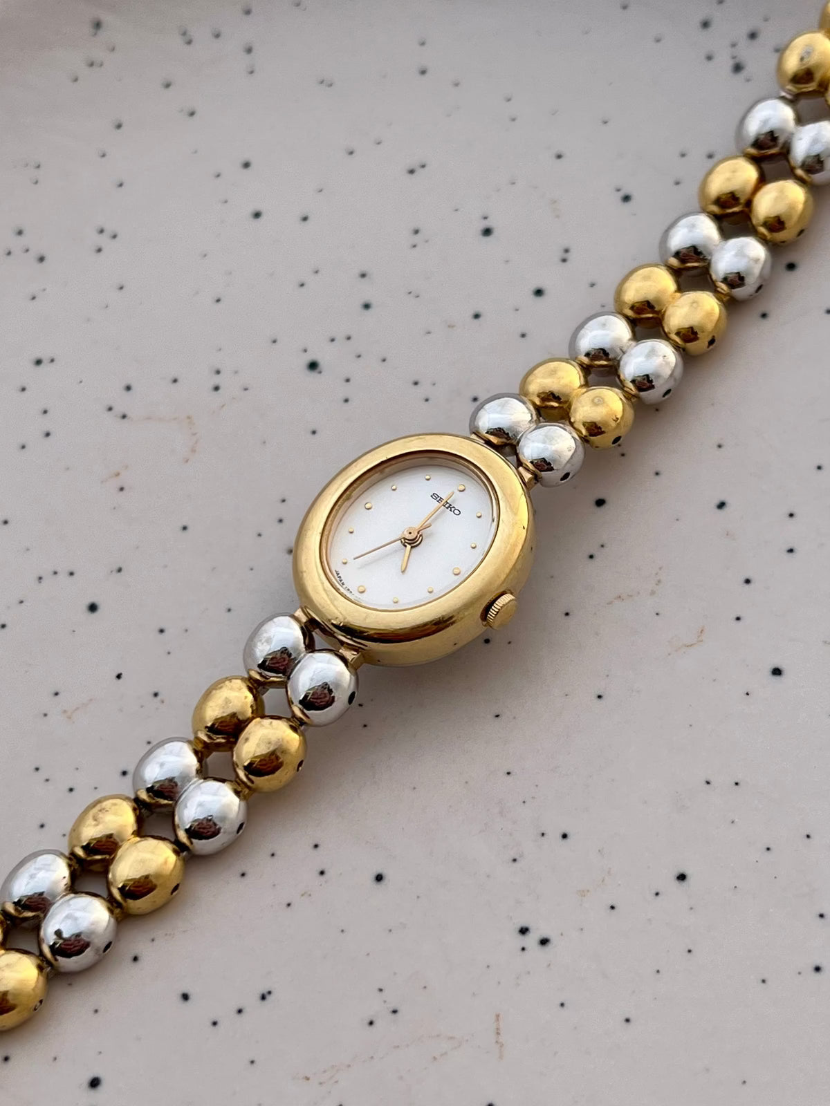 Seiko two-tone oval watch and presentation box.