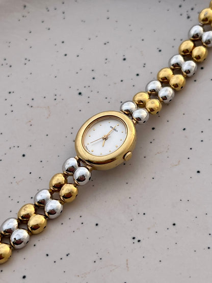 Seiko two-tone oval watch and presentation box.