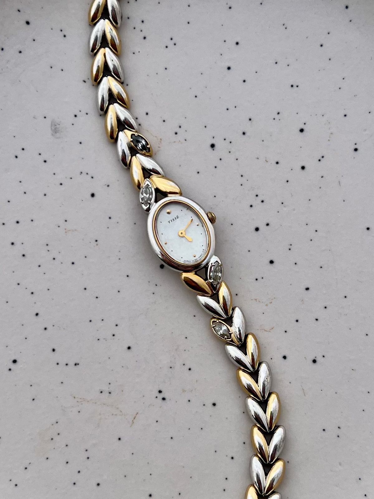 Dial detail showing the Seiko watch's mother-of-pearl face, gilt hands and applied markers.