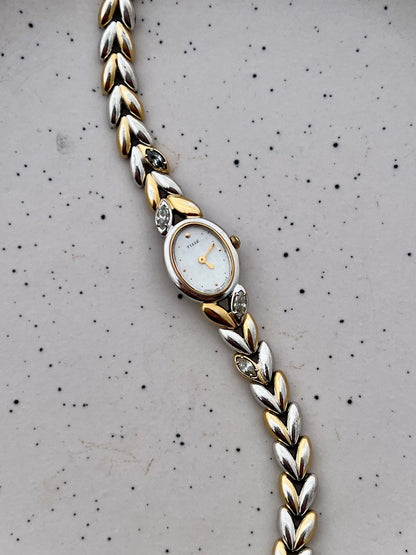 Dial detail showing the Seiko watch's mother-of-pearl face, gilt hands and applied markers.