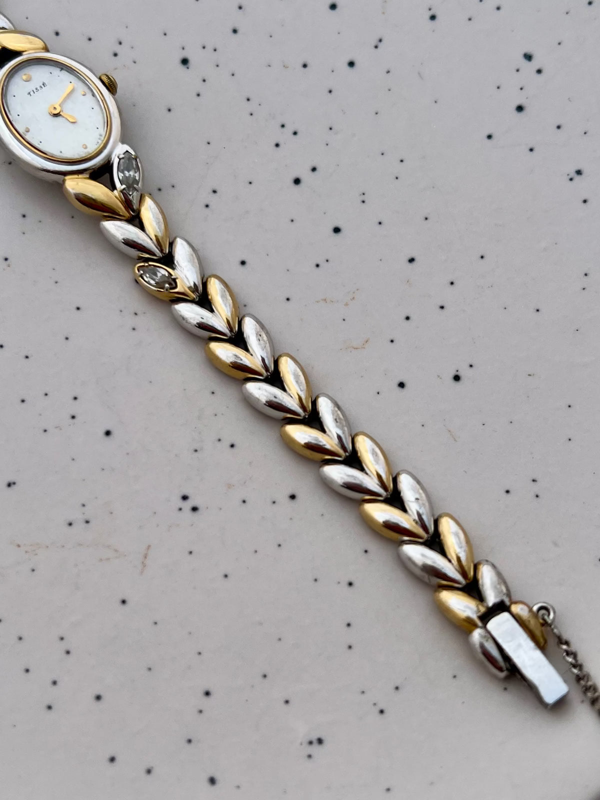 Detail of the Seiko two-tone leaf bracelet with embedded gemstones.