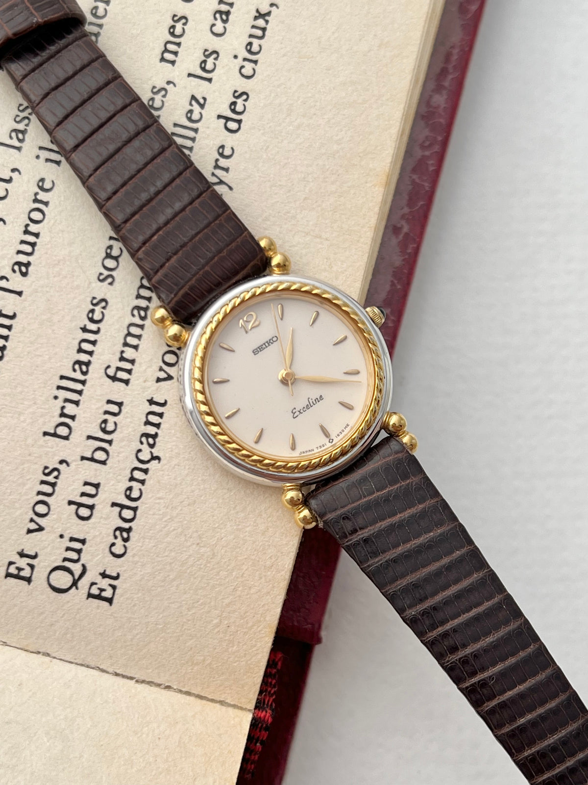 Seiko Two Toned Rope Bezel Woman's Watch — the watch arranged with jewellery on a light display surface.