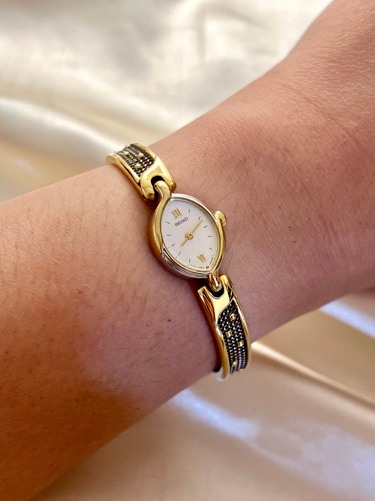 Seiko Tissé Oval Roman Dial Two Tone Bangle Women's Watch — product photograph 5
