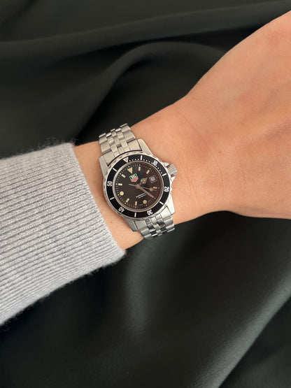TAG Heuer 1500 Professional 200M WD1410 G 20 watch worn on wrist with black dial, rotating bezel, date window and stainless steel bracelet