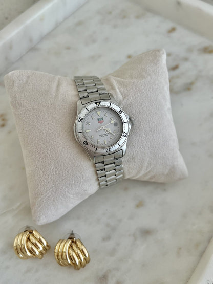 TAG Heuer 2000 Professional watch on steel bracelet, displayed on a cream cushion