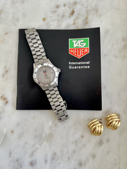 TAG Heuer 2000 Professional watch photographed beside TAG Heuer guarantee booklet