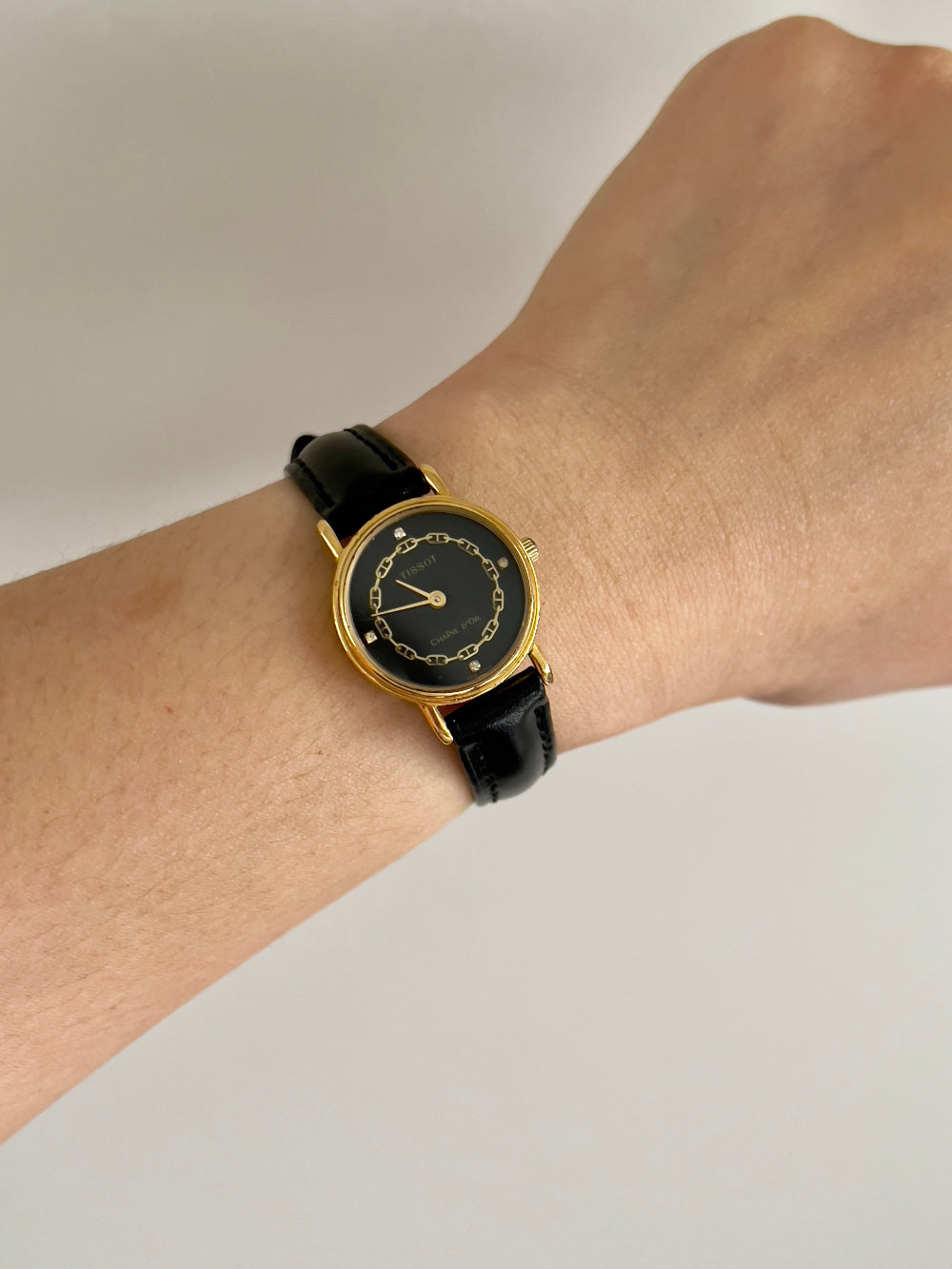 Tissot Chaîne d’Or Black Dial Chain Motif Women’s Watch; black stitched leather strap and gold tone buckle. Product photograph 2 of 10.
