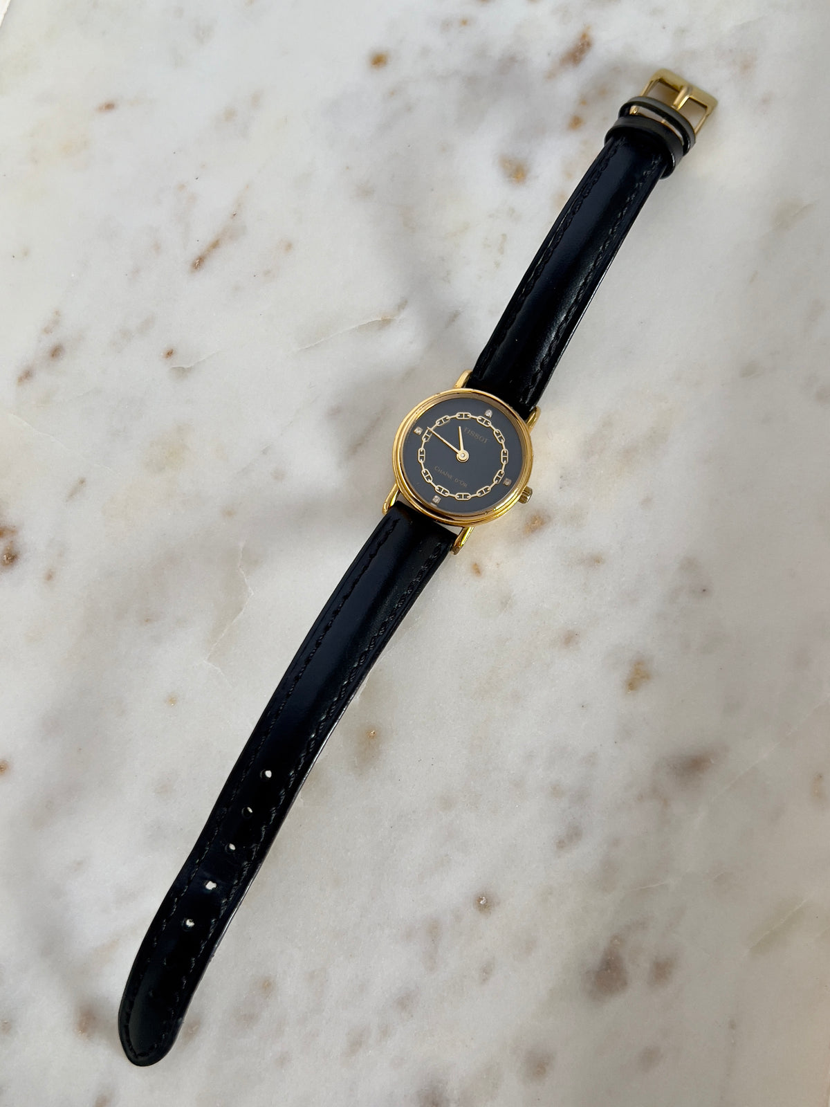 Tissot Chaîne d’Or Black Dial Chain Motif Women’s Watch; black stitched leather strap and gold tone buckle. Product photograph 4 of 10.