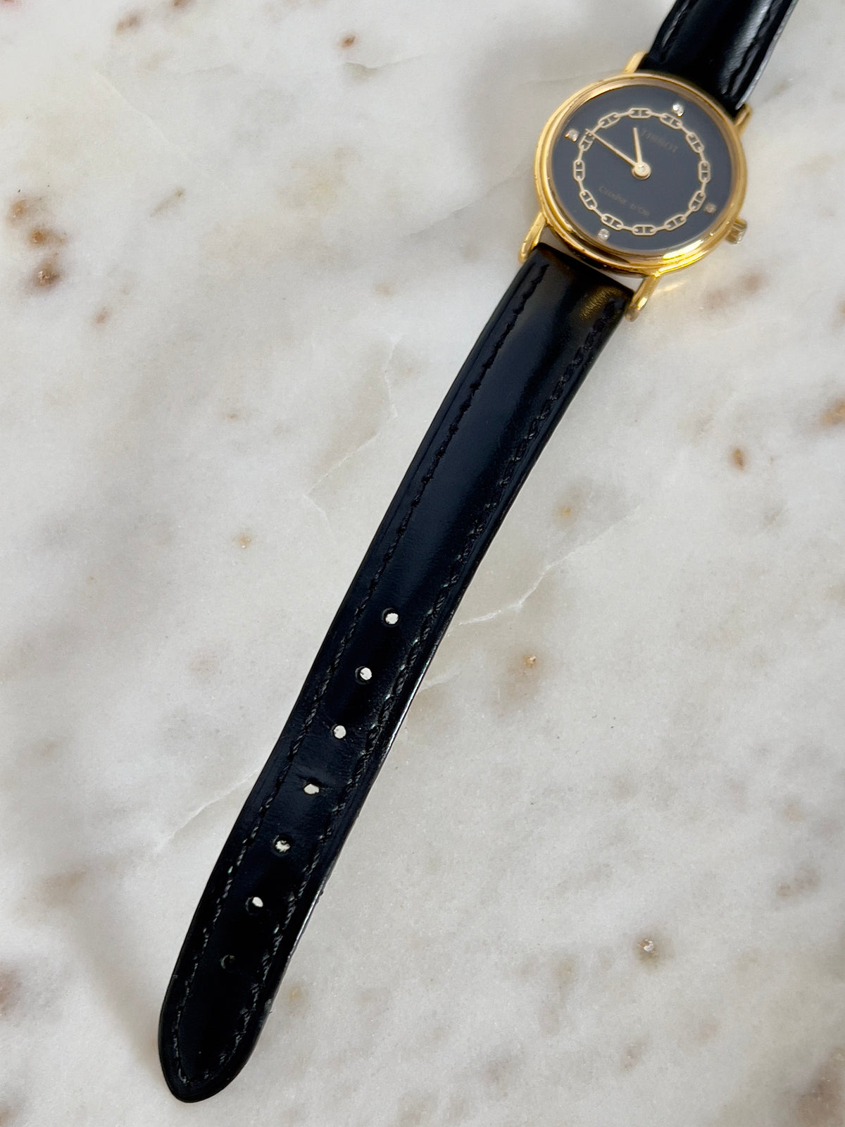 Tissot Chaîne d’Or Black Dial Chain Motif Women’s Watch; black stitched leather strap and gold tone buckle. Product photograph 5 of 10.