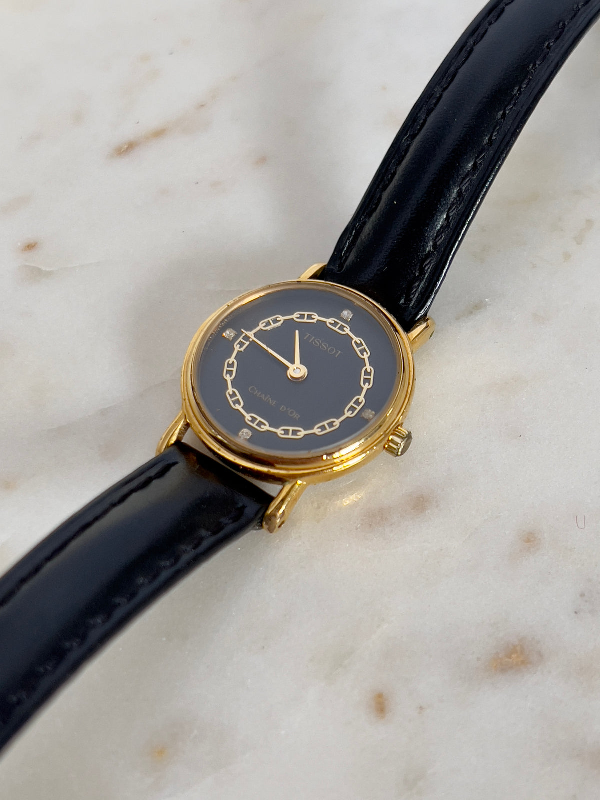 Tissot Chaîne d’Or Black Dial Chain Motif Women’s Watch; black stitched leather strap and gold tone buckle. Product photograph 7 of 10.