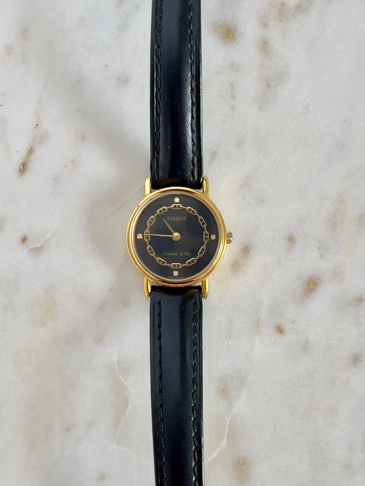 Tissot Chaîne d’Or Black Dial Chain Motif Women’s Watch; black stitched leather strap and gold tone buckle. Product photograph 8 of 10.