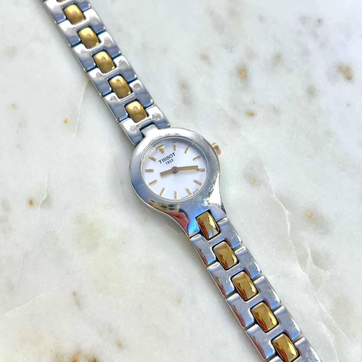 Tissot White Dial Two Tone Bracelet Women’s Watch; two tone bracelet with broad silver tone links and gold tone connectors. Product photograph 1 of 11.