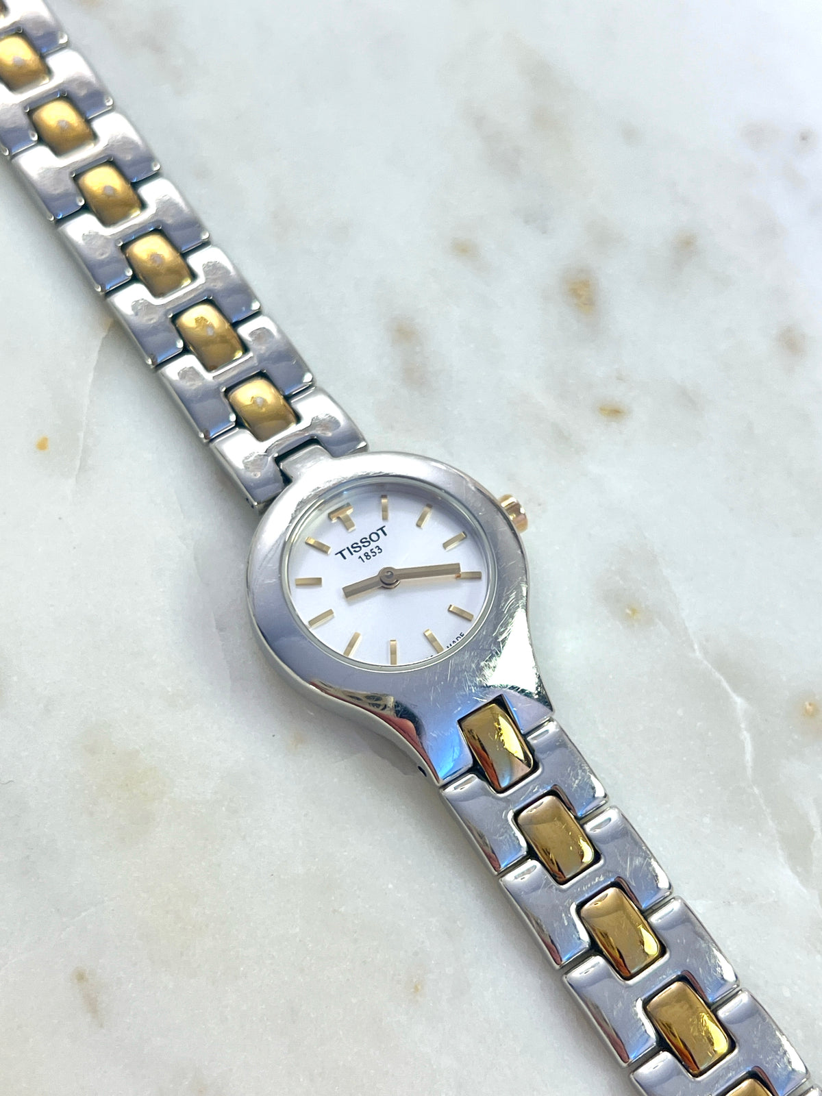 Tissot White Dial Two Tone Bracelet Women’s Watch; two tone bracelet with broad silver tone links and gold tone connectors. Product photograph 2 of 11.