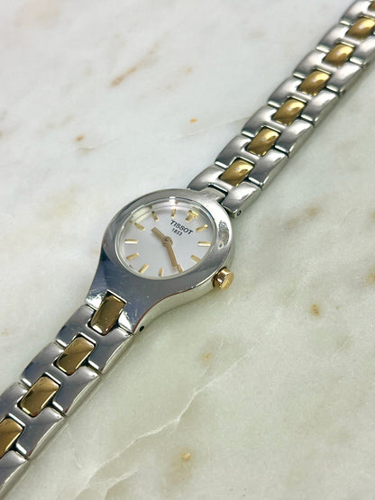 Tissot White Dial Two Tone Bracelet Women’s Watch; two tone bracelet with broad silver tone links and gold tone connectors. Product photograph 9 of 11.