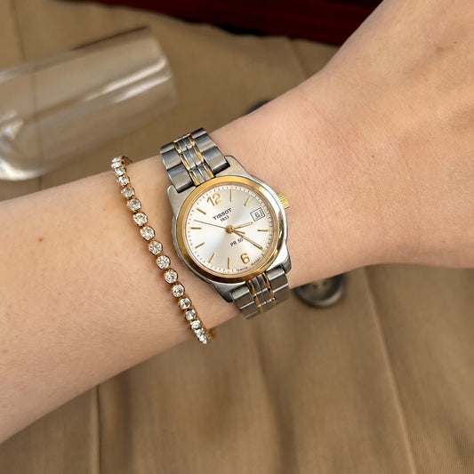 Tissot PR 50 two tone women’s watch with pale silver dial, pictured on a 15 cm wrist