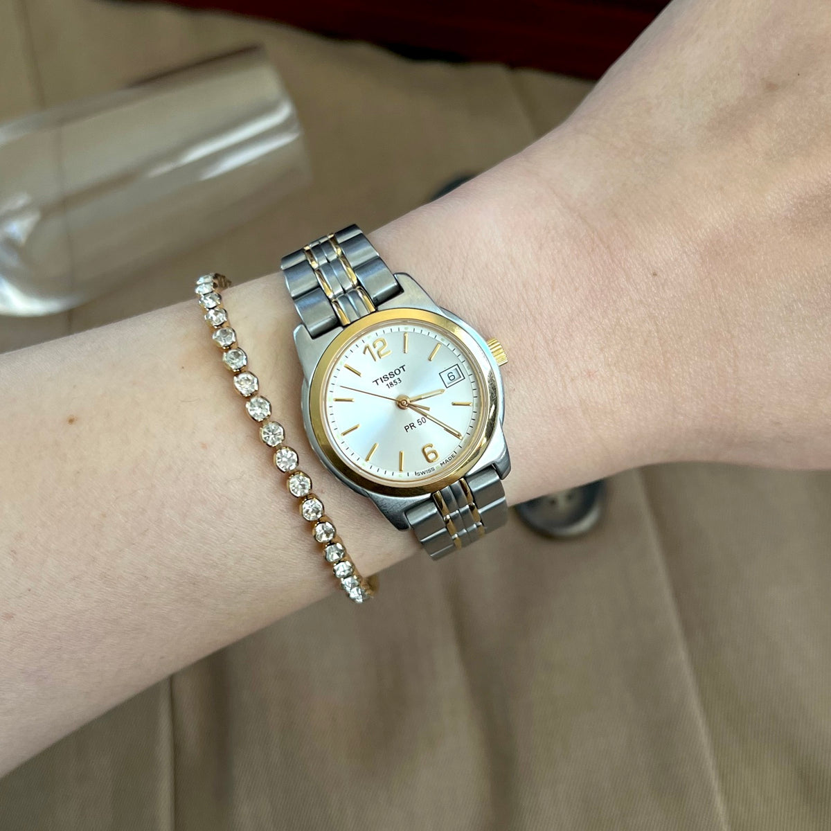 Tissot PR 50 two tone women’s watch with pale silver dial, pictured on a 15 cm wrist