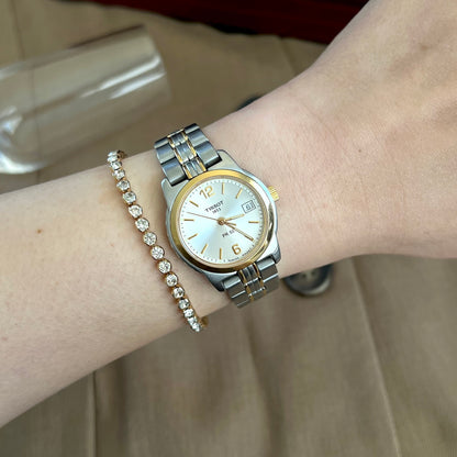 Tissot PR 50 two tone women’s watch with pale silver dial, pictured on a 15 cm wrist