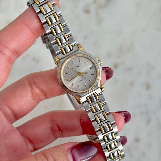 Tissot Seastar two-tone ladies watch with vertically textured silver dial and date display.