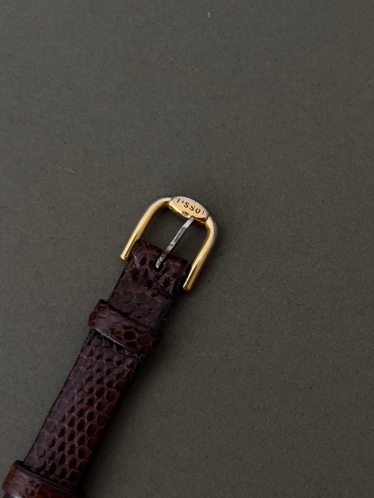 Tissot Stylist Gold Cushion Women’s Watch with Patterned Dial — Tissot buckle and leather strap.