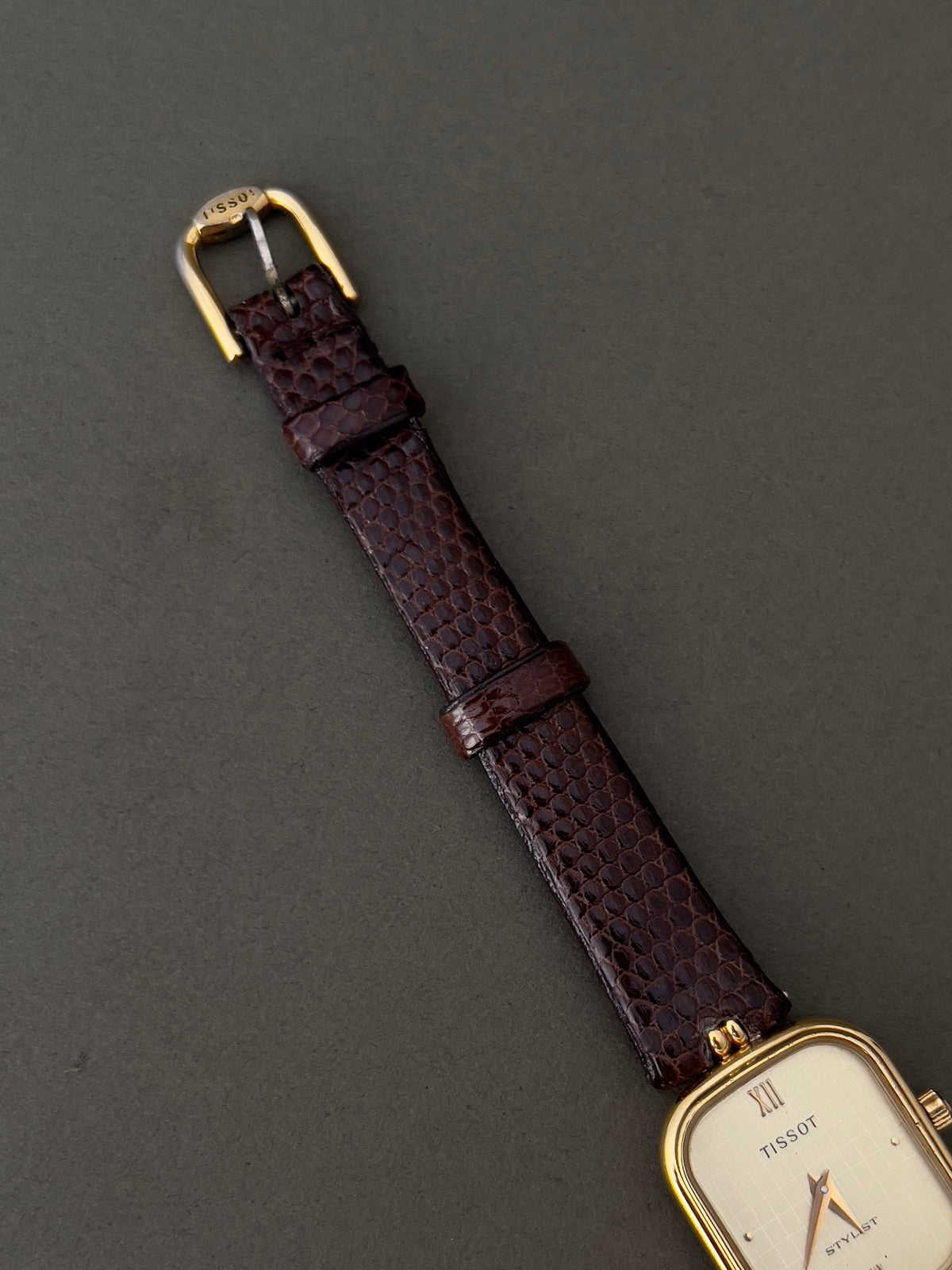 Tissot Stylist Gold Cushion Women’s Watch with Patterned Dial — close view of dial, strap and buckle.