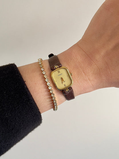 Tissot Stylist Gold Cushion Women’s Watch with Patterned Dial — watch worn on the wrist.