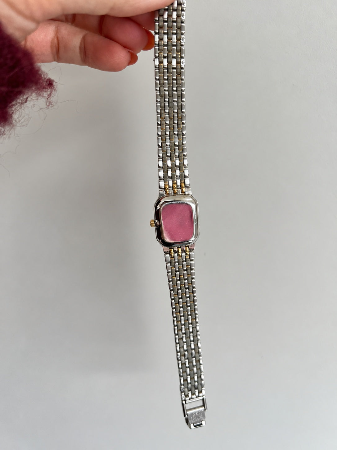 Polished Tissot Stylist caseback and underside of the two tone bracelet and folding clasp.