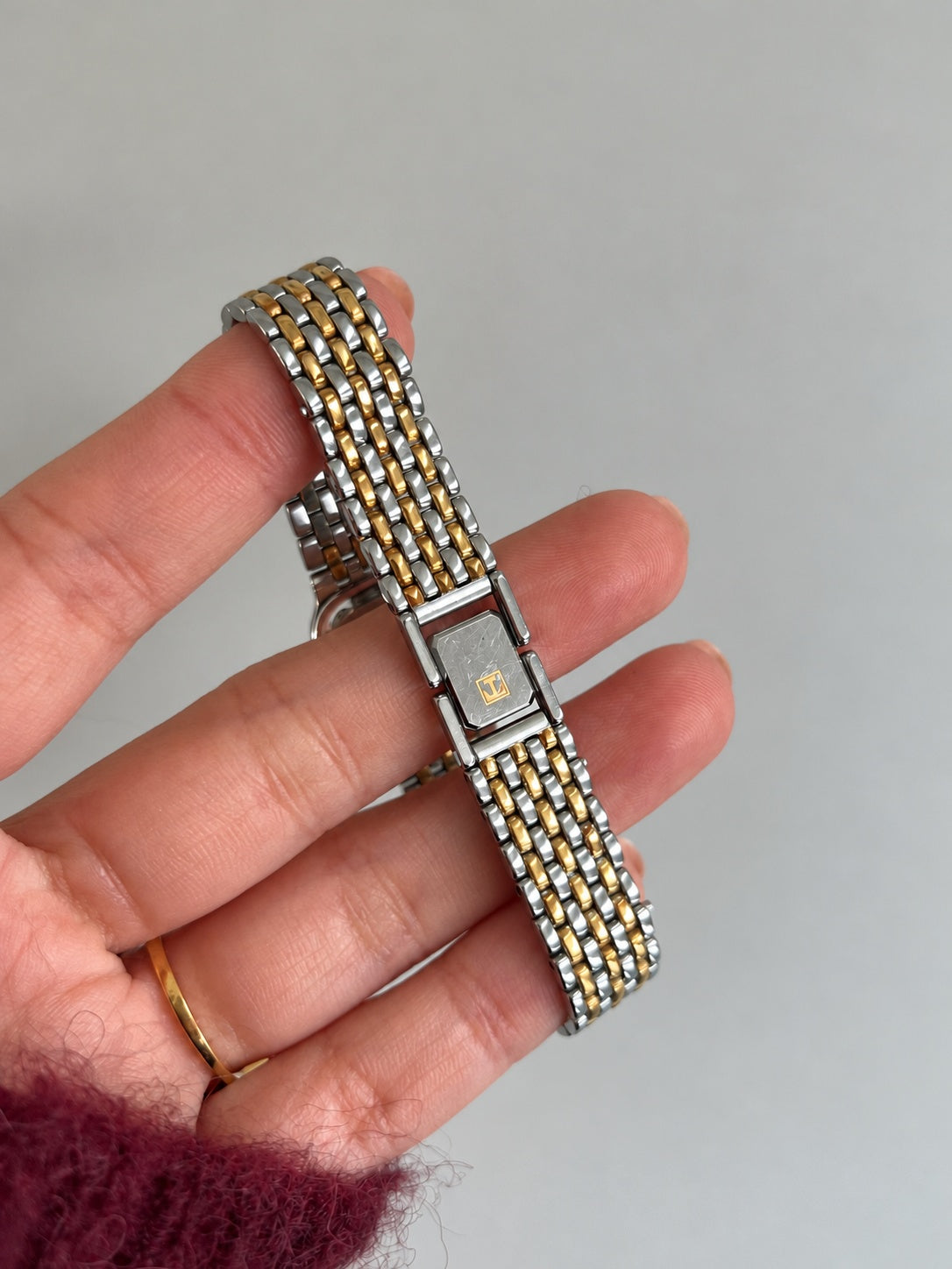 Tissot T emblem on the folding jewellery clasp of the two tone link bracelet.