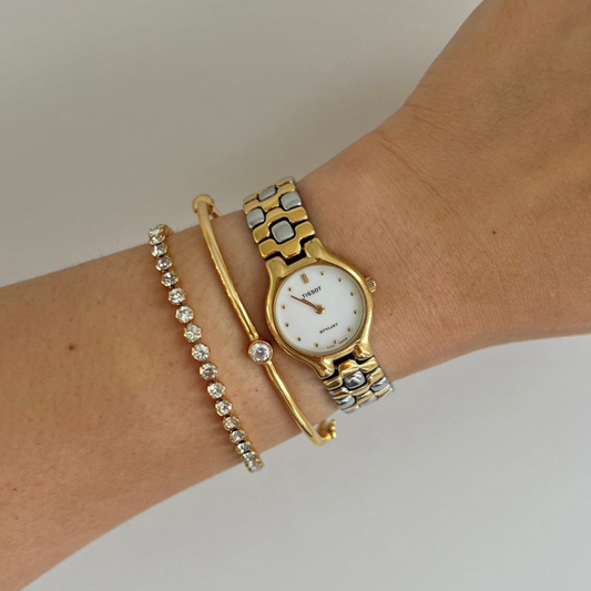 Tissot Stylist two-tone ladies watch with bright white dial, front view.