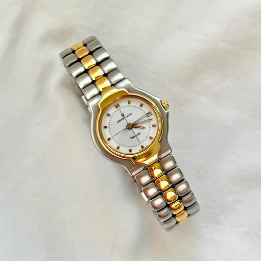 Universal Genève Polerouter women’s two tone Swiss watch with integrated bracelet, white dial, gold tone bezel and elegant luxury sport design.
