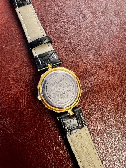 Vintage Rado women's watch with a flower-shaped two-tone case and honeycomb dial, shown from the back.