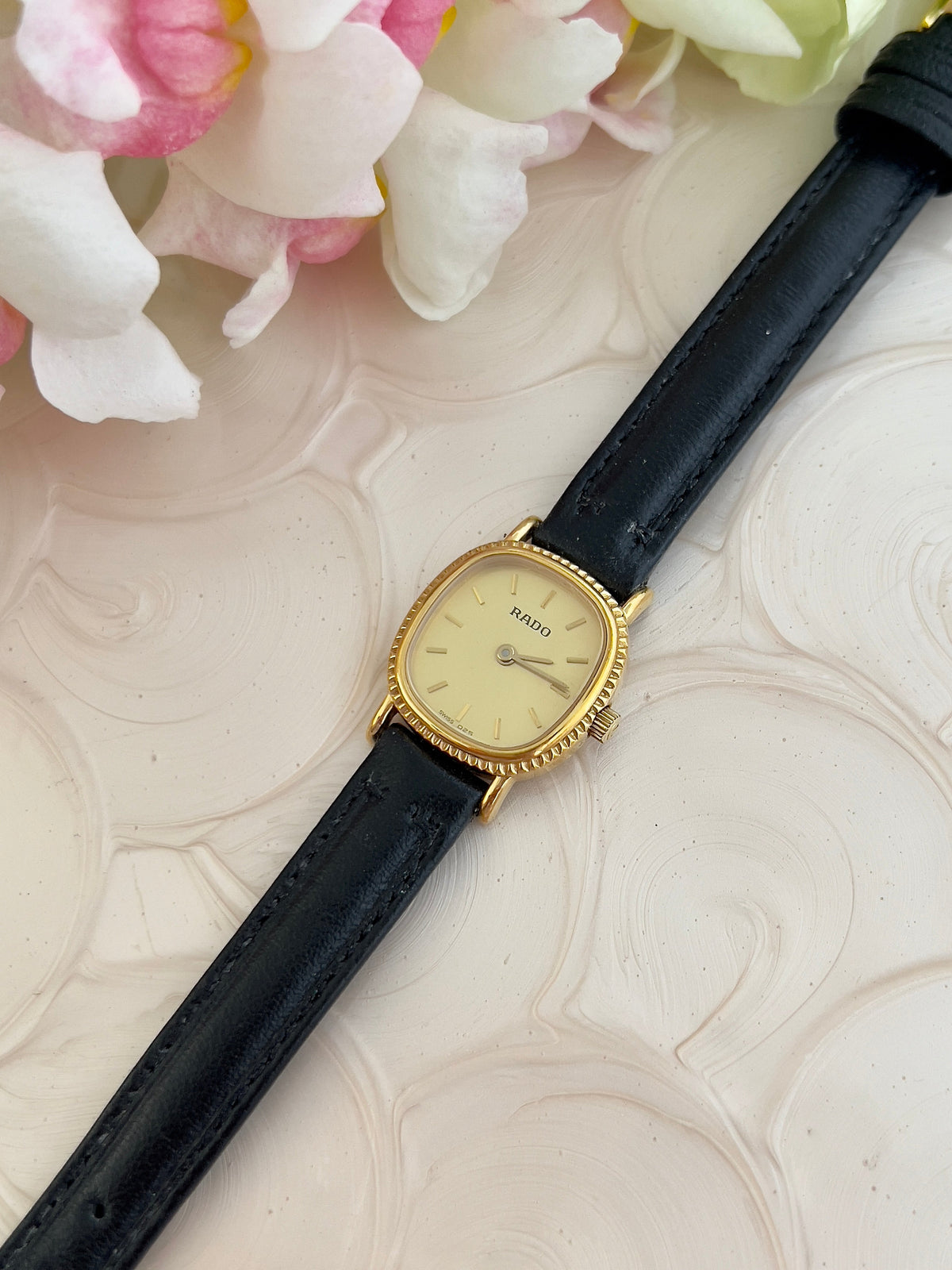 Rado Gold Cushion Women’s Watch with Fluted Case — angled view of gold case.